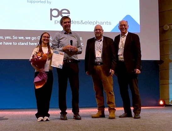 Chiara Huber on stage with her Best Poster Award